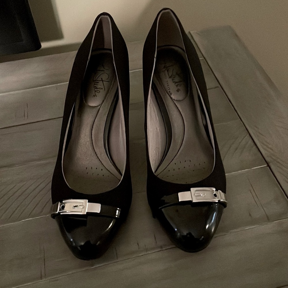Black patent leather heels with silver buckle.  Only worn once.
